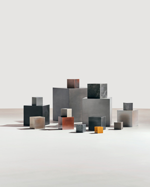 Metal blocks representing materials in an electric car, including iron, copper, zinc, cobalt, aluminum, lithium, and manganese.